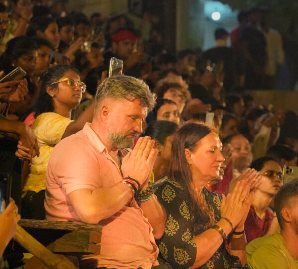 Tourists enjoying the Evening Ganga Aarti from a private boat in Varanasi