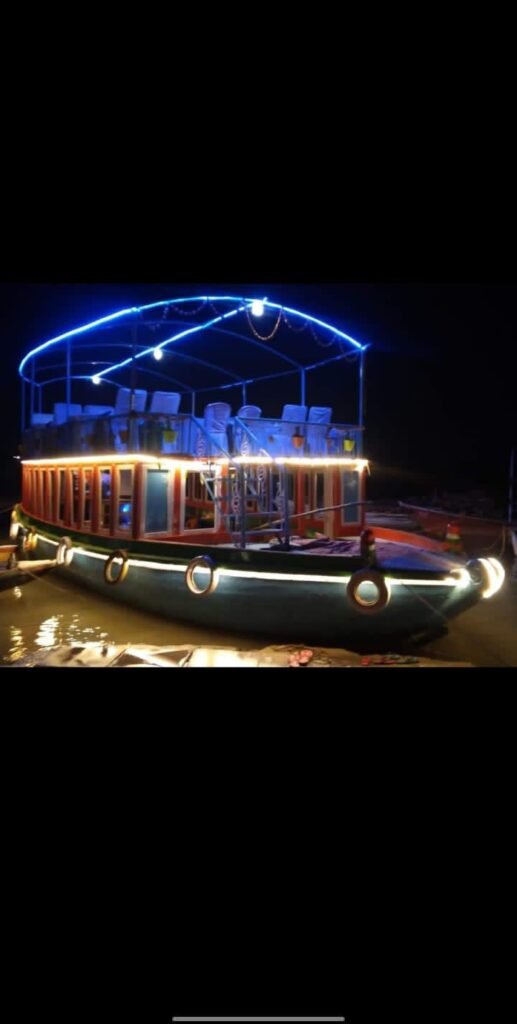 Traditional bajra boat on the Ganges in Varanasi during evening Ganga Aarti with glowing diyas