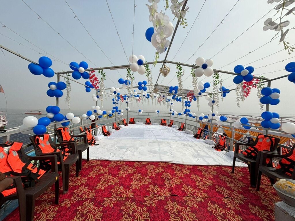 Bajra boat decorated with balloons, lights, and fresh flowers for a celebration event on the Ganges in Varanasi