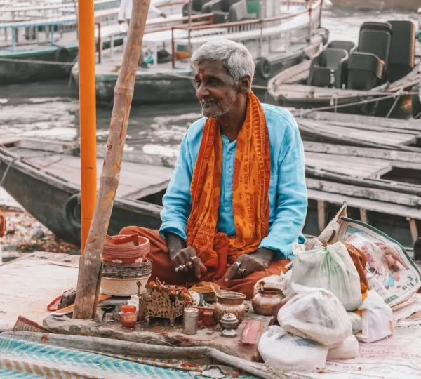 Priest performing rituals for Pind Daan at riverbank.