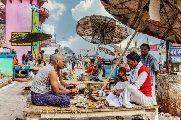 Pind Daan services being performed by a Hindu priest at a ghat in Varanasi for ancestral rituals