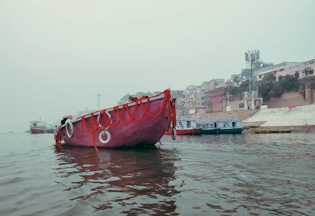 Decorated boat ride on the Ganga river near Varanasi ghats during Dev Diwali festival.