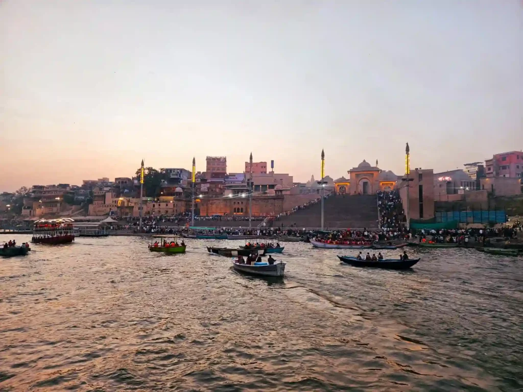Evening view of Varanasi ghats during bajra boat ride at sunset before Ganga Aarti ceremony.